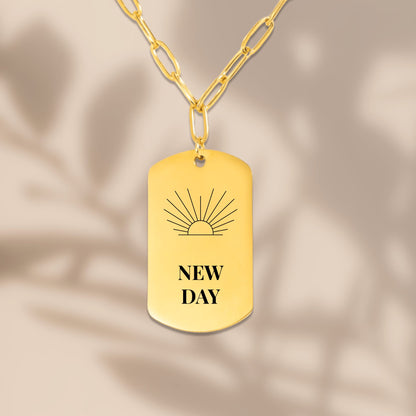 Sunrise engraved tag pendant with soft leaf shadows