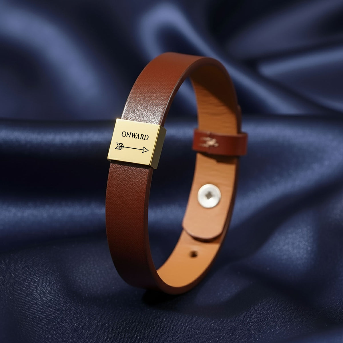 Onward arrow engraved plate on a brown leather-look band, close up