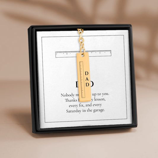 Dad ruler vertical bar keychain on its DAD message card in a gift box