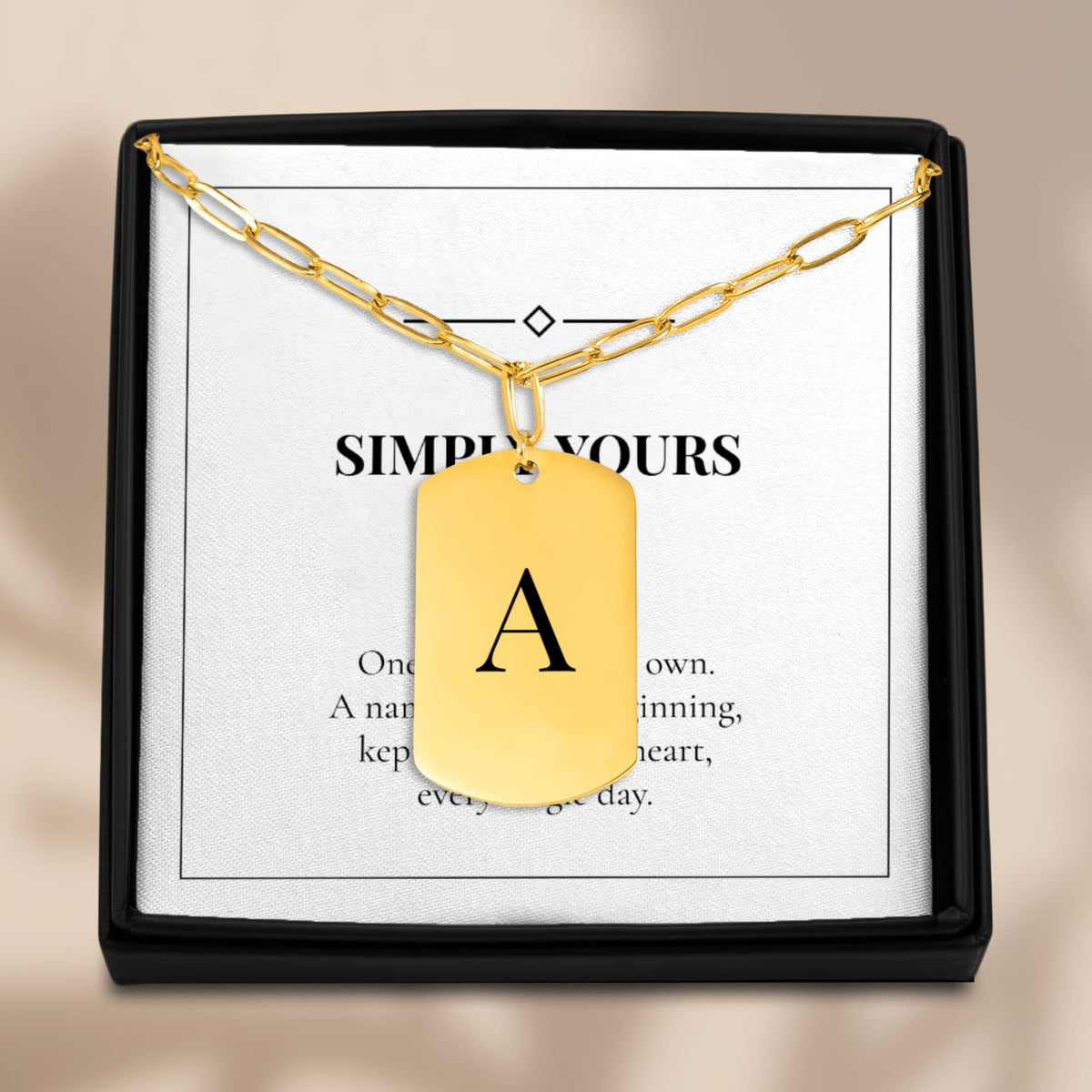 Initial tag necklace in an open gift box with its message card