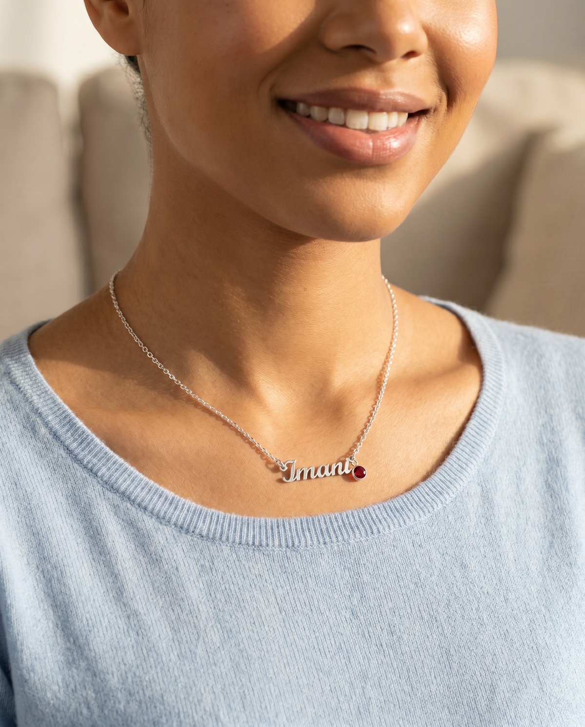 Smiling woman in a blue top wearing the name necklace | Name Necklace with Birthstone