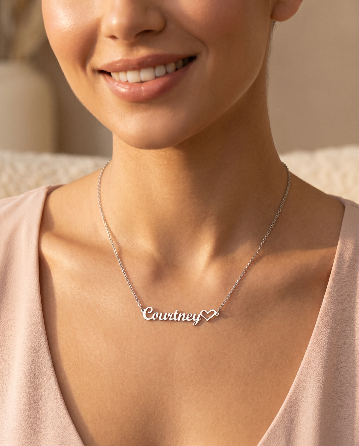 Woman wearing the heart name necklace at her collarbone