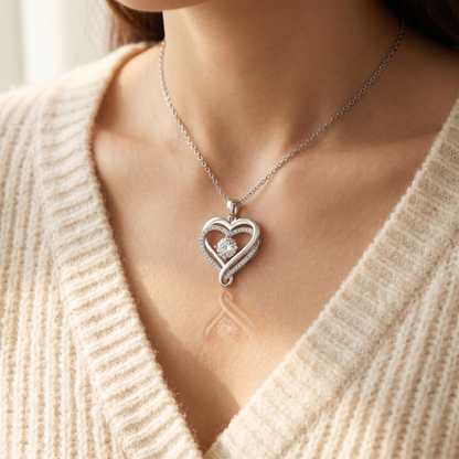 Woman in a cream sweater wearing the ribbon heart pendant | Love You Always Necklace