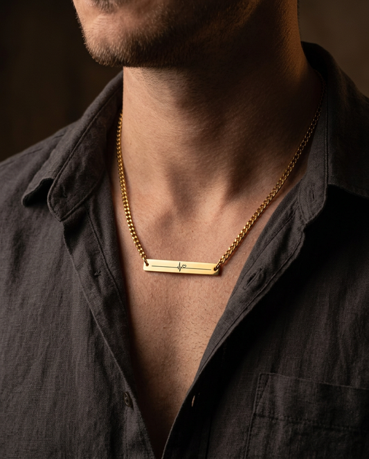 Heartbeat bar necklace on a Cuban chain worn over a charcoal shirt (styled lifestyle image)